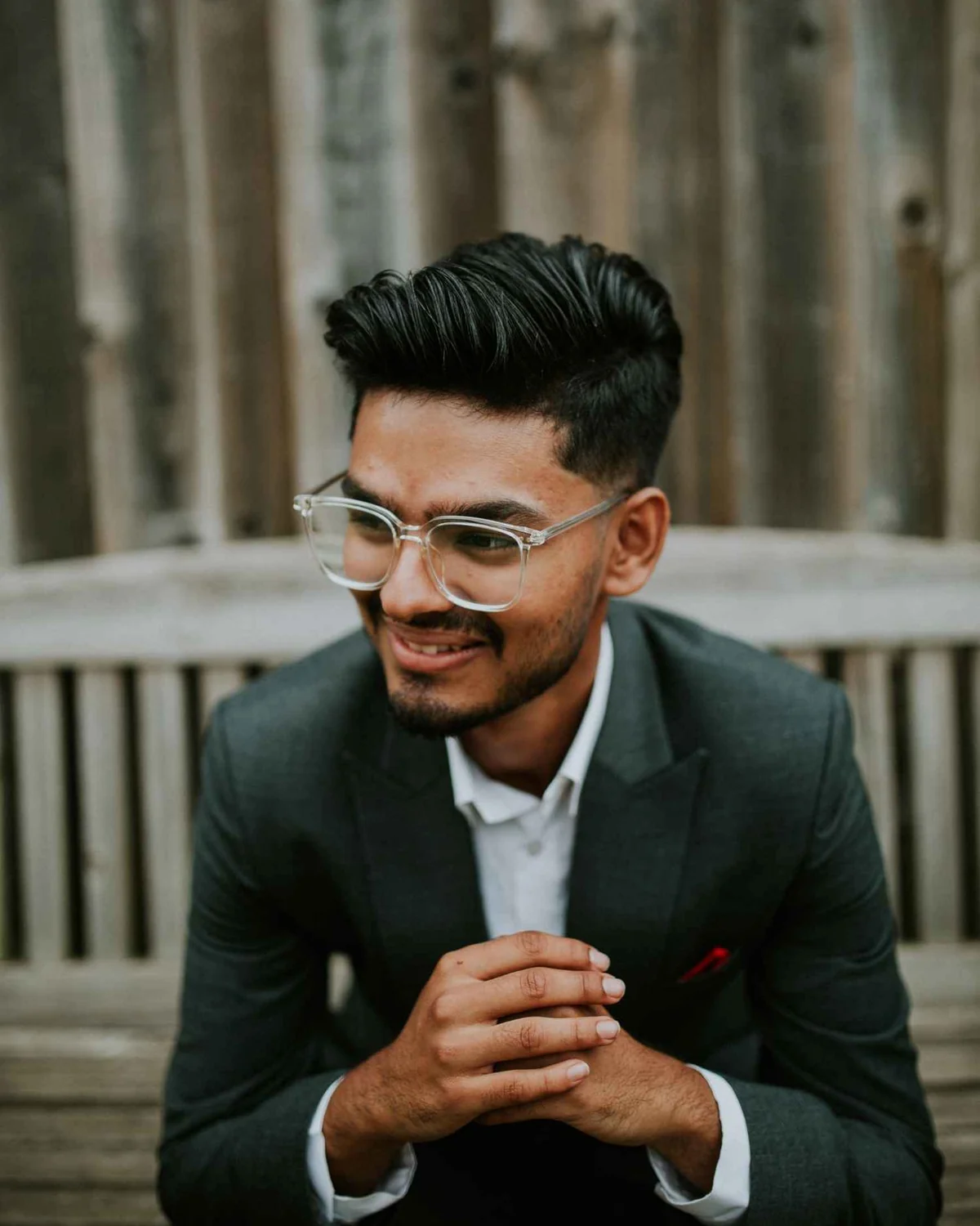 Puskar Silwal, smiling, in a dark suit and clear glasses